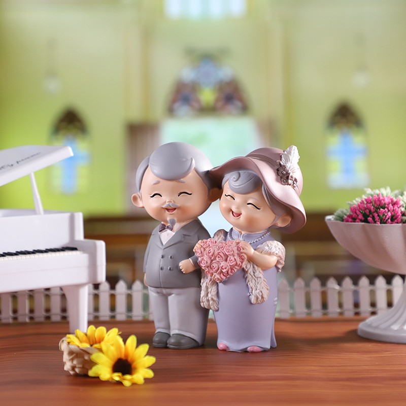 Statue of modern grandparents - holding flowers